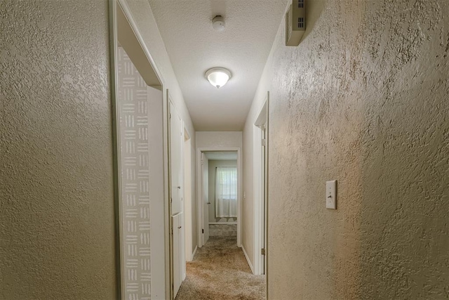 5717 NW 31st Ter, Oklahoma City, OK 73122 - hallway featuring carpet and a textured wall