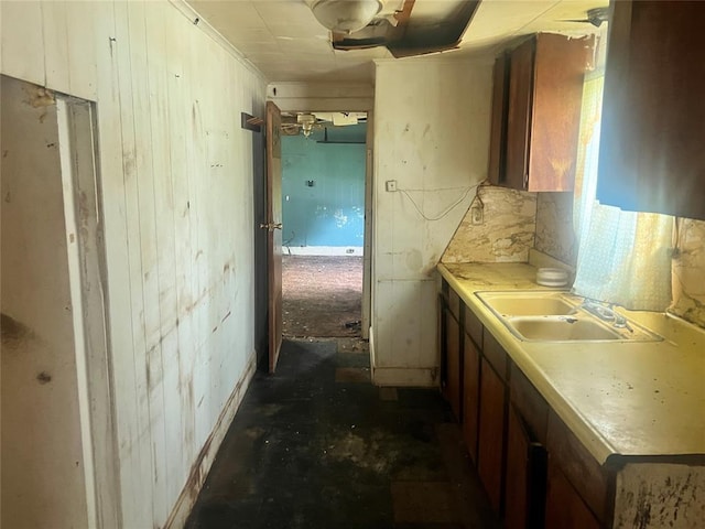 307 W Walnut Ave, Seminole, OK 74868 - kitchen with wood walls and light countertops