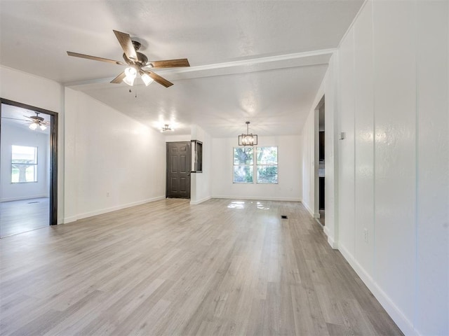 9200 Hollow Rd, Newalla, OK 74857 - unfurnished living room featuring plenty of natural light, a chandelier, a ceiling fan, and light wood-style flooring
