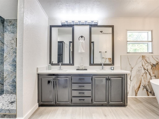 9200 Hollow Rd, Newalla, OK 74857 - bathroom with double vanity, wood finished floors, a soaking tub, tiled shower, and ornamental molding