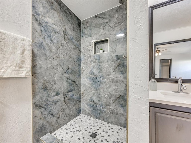 9200 Hollow Rd, Newalla, OK 74857 - bathroom with a tile shower, a textured wall, and vanity