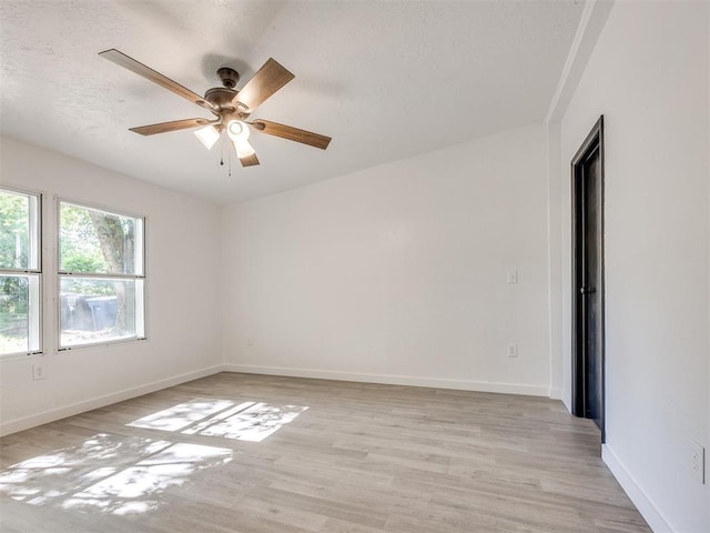 9200 Hollow Rd, Newalla, OK 74857 - empty room with light wood-type flooring, ceiling fan, and a textured ceiling