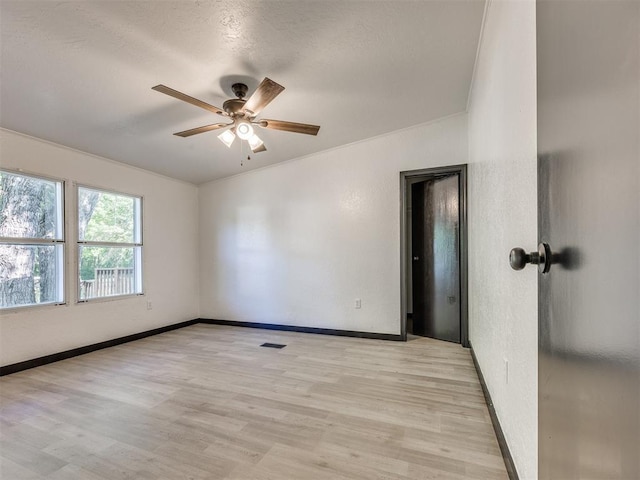 9200 Hollow Rd, Newalla, OK 74857 - unfurnished room with a ceiling fan, light wood-style flooring, a textured wall, and a textured ceiling