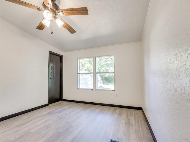 9200 Hollow Rd, Newalla, OK 74857 - empty room with light wood finished floors, a ceiling fan, and a textured wall
