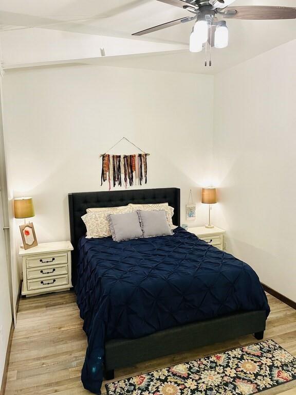115008 S 4292nd Rd, Porum, OK 74455 - bedroom with light wood-style floors and ceiling fan