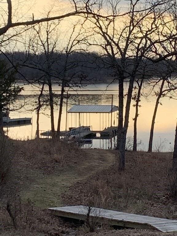 115008 S 4292nd Rd, Porum, OK 74455 - yard at dusk featuring a dock