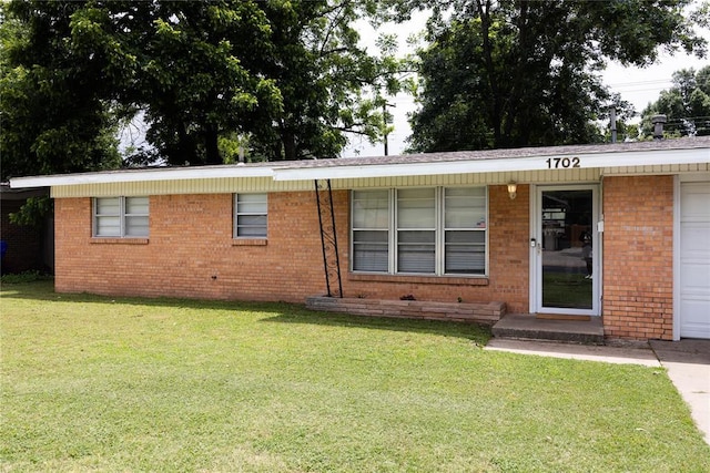 1702 W Boyd St, Norman, OK 73069 - ranch-style house with a front yard and brick siding