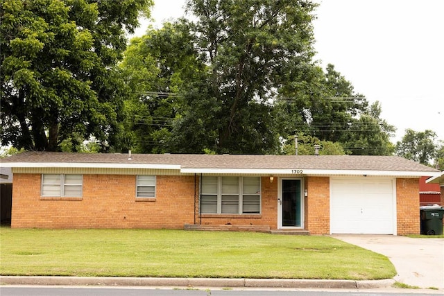 1702 W Boyd St, Norman, OK 73069 - ranch-style house with an attached garage, concrete driveway, a front yard, and brick siding