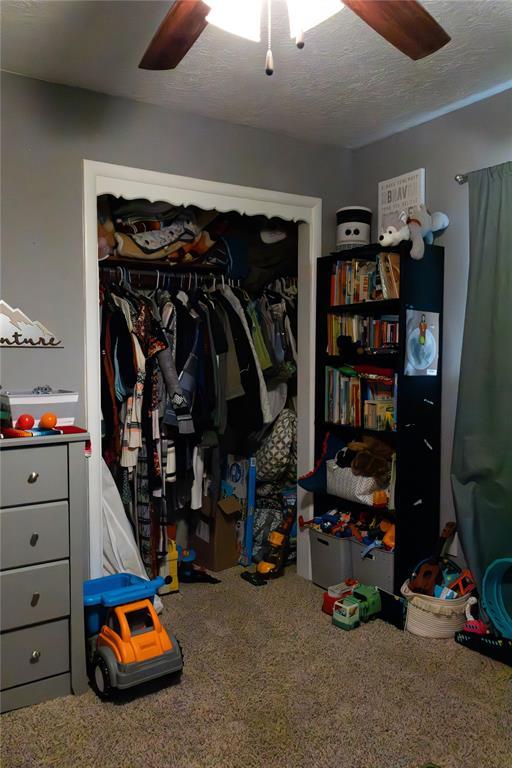 1702 W Boyd St, Norman, OK 73069 - carpeted bedroom with a closet and ceiling fan