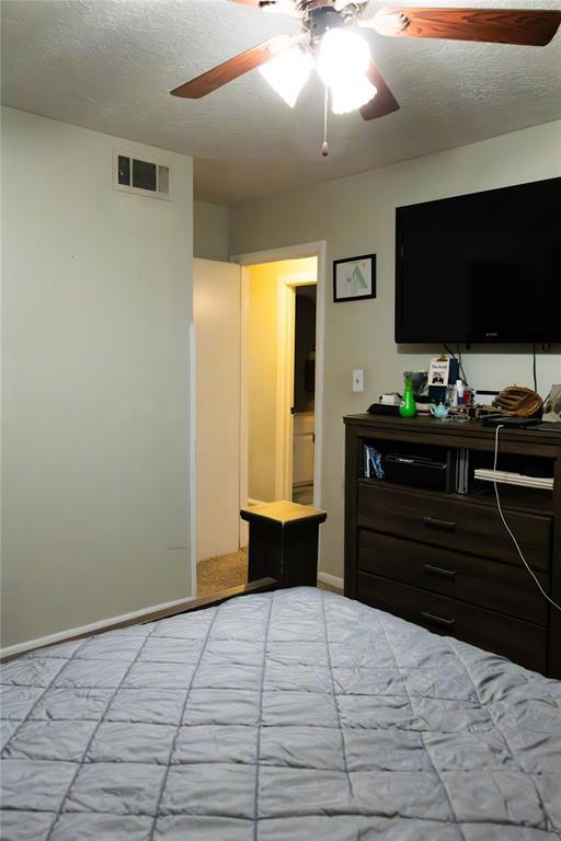 1702 W Boyd St, Norman, OK 73069 - bedroom with a ceiling fan
