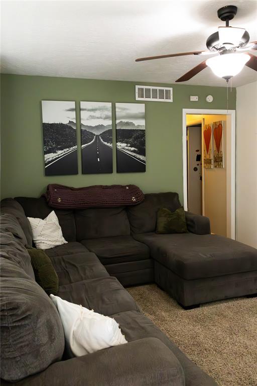 1702 W Boyd St, Norman, OK 73069 - carpeted living room featuring a ceiling fan