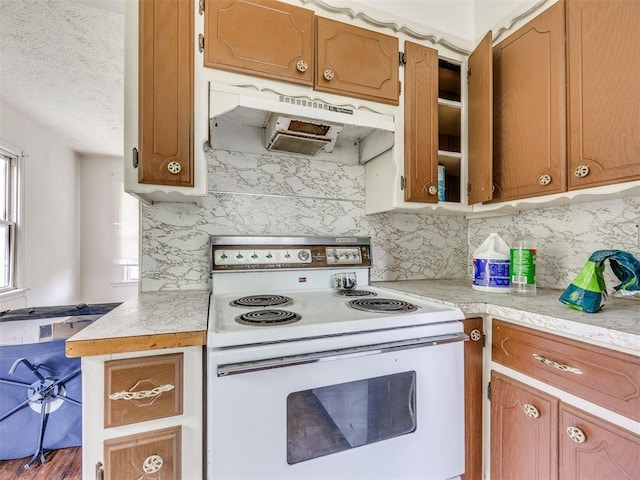 9424 NE 28th St, Oklahoma City, OK 73141 - kitchen featuring electric stove, under cabinet range hood, light countertops, tasteful backsplash, and brown cabinets