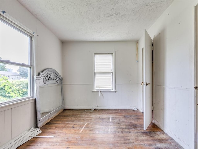 9424 NE 28th St, Oklahoma City, OK 73141 - spare room with a textured ceiling, light wood-style floors, and healthy amount of natural light