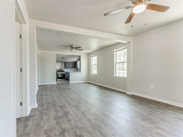 321 W Farrall Ave, Shawnee, OK 74801 - unfurnished living room with ceiling fan and wood finished floors