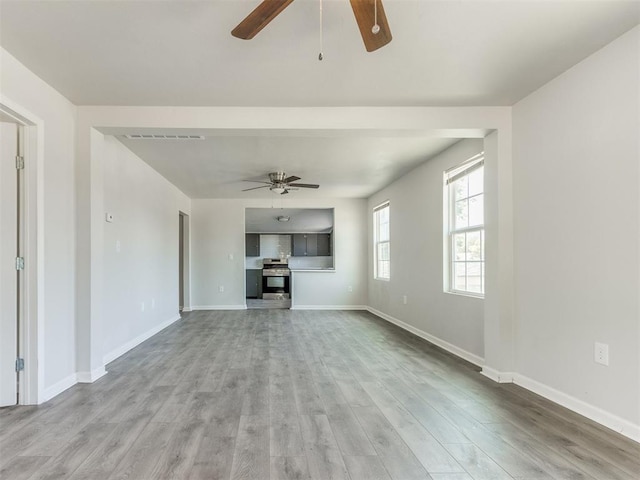 321 W Farrall Ave, Shawnee, OK 74801 - unfurnished living room with ceiling fan and wood finished floors