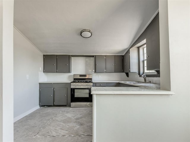 321 W Farrall Ave, Shawnee, OK 74801 - kitchen with gas range, gray cabinetry, tasteful backsplash, and tile countertops