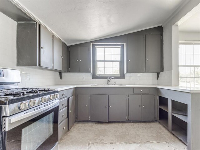 321 W Farrall Ave, Shawnee, OK 74801 - kitchen featuring gas stove, lofted ceiling, gray cabinets, healthy amount of natural light, and tasteful backsplash