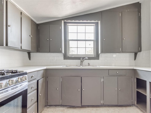 321 W Farrall Ave, Shawnee, OK 74801 - kitchen featuring gray cabinets, gas range, backsplash, light countertops, and lofted ceiling