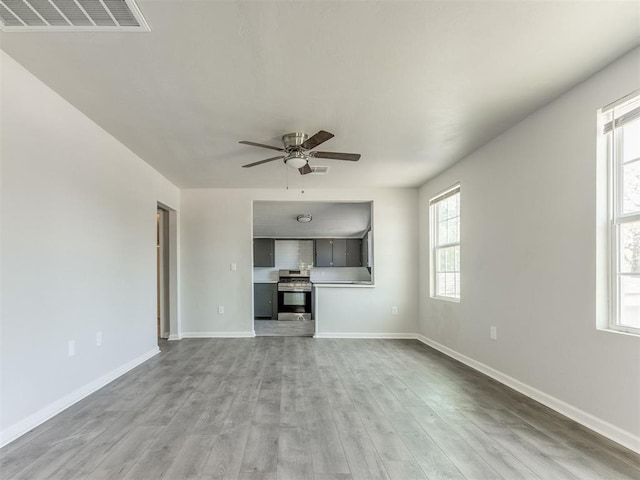 321 W Farrall Ave, Shawnee, OK 74801 - unfurnished living room featuring a ceiling fan and light wood finished floors