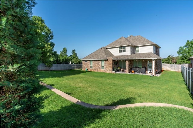508 Mirano Ln, Edmond, OK 73034 - back of house with a fenced backyard, a shingled roof, a patio, and brick siding