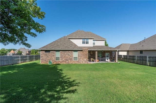 508 Mirano Ln, Edmond, OK 73034 - back of property with brick siding, a fenced backyard, a shingled roof, and a patio