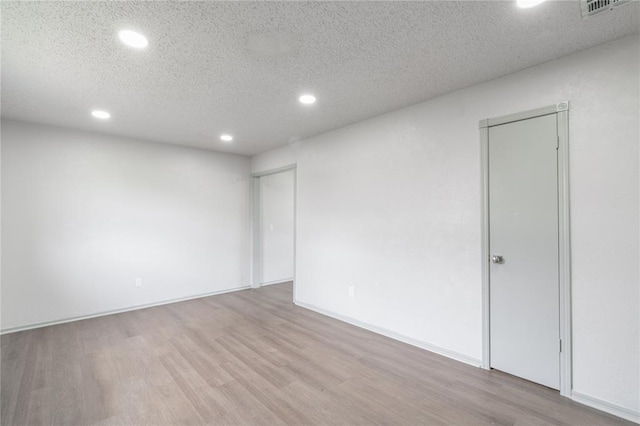 4720 S Youngs Blvd, Oklahoma City, OK 73119 - unfurnished room featuring recessed lighting, wood finished floors, and a textured ceiling