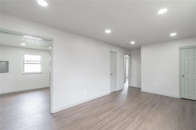 4720 S Youngs Blvd, Oklahoma City, OK 73119 - spare room with light wood-type flooring, recessed lighting, and a textured ceiling