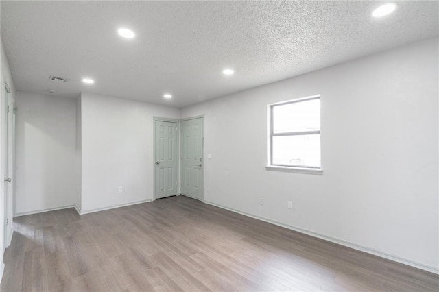 4720 S Youngs Blvd, Oklahoma City, OK 73119 - empty room with recessed lighting, wood finished floors, and a textured ceiling