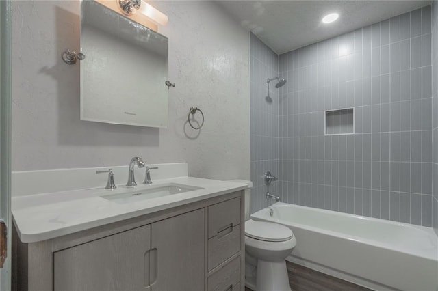 4720 S Youngs Blvd, Oklahoma City, OK 73119 - bathroom with a textured wall, vanity, washtub / shower combination, wood finished floors, and recessed lighting