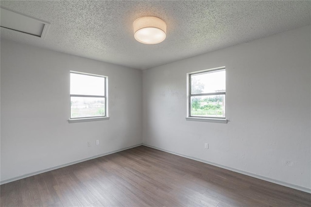 4720 S Youngs Blvd, Oklahoma City, OK 73119 - empty room featuring wood finished floors and a textured ceiling