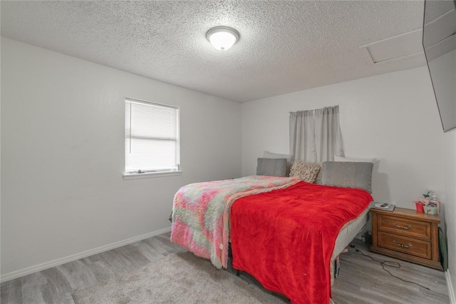 4720 S Youngs Blvd, Oklahoma City, OK 73119 - bedroom with wood finished floors, a textured ceiling, and attic access