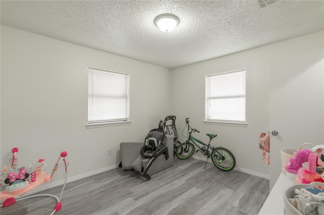 4720 S Youngs Blvd, Oklahoma City, OK 73119 - playroom featuring wood finished floors and a textured ceiling