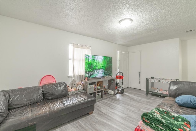 4720 S Youngs Blvd, Oklahoma City, OK 73119 - living room featuring a textured ceiling and wood finished floors