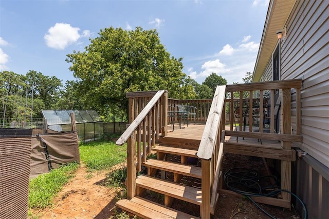 4040 Logan Hills Dr, Guthrie, OK 73044 - wooden terrace with an exterior structure, an outdoor structure, and view of scattered trees