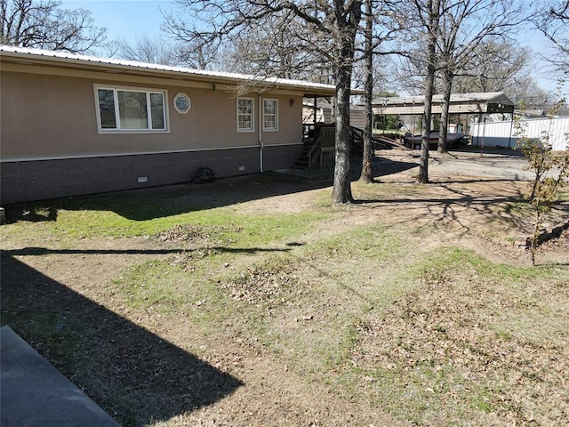 273 N Elm St Unit 1, Eufaula, OK 74432 - view of side of property featuring a detached carport, a metal roof, stairs, and crawl space