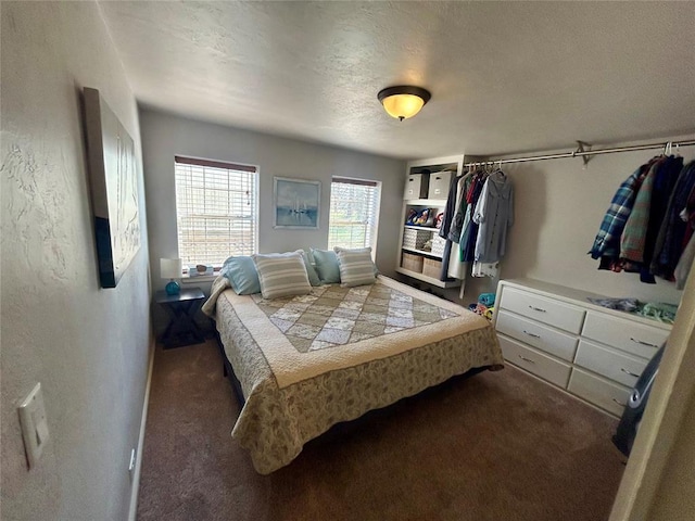 273 N Elm St Unit 1, Eufaula, OK 74432 - bedroom featuring dark carpet, a textured ceiling, and a textured wall