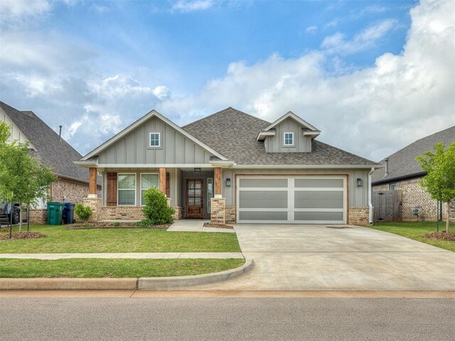 2436 NW 179th St, Edmond, OK 73012 - craftsman-style home with board and batten siding, driveway, a garage, brick siding, and a shingled roof