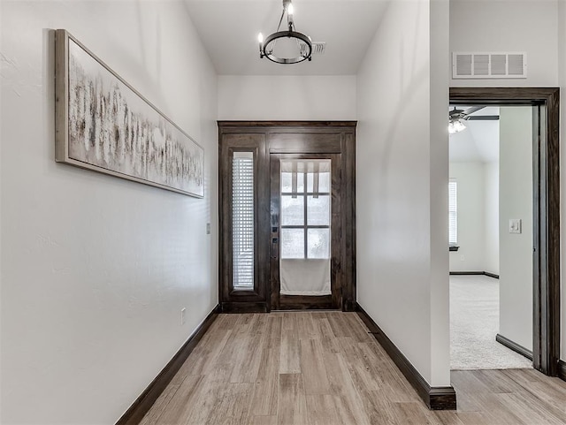 2436 NW 179th St, Edmond, OK 73012 - entryway with light wood-type flooring, a chandelier, and a ceiling fan