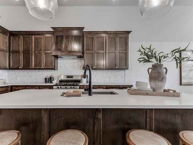 2436 NW 179th St, Edmond, OK 73012 - kitchen featuring gas range, a breakfast bar area, and light countertops