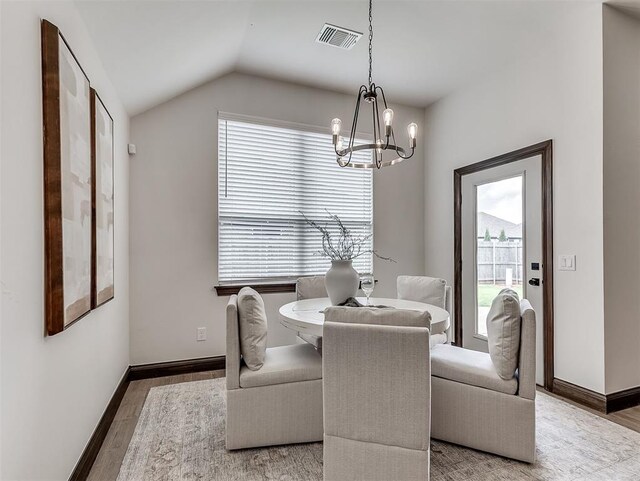 2436 NW 179th St, Edmond, OK 73012 - dining area featuring wood finished floors, a chandelier, and lofted ceiling