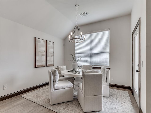2436 NW 179th St, Edmond, OK 73012 - dining area featuring a chandelier, wood finished floors, and vaulted ceiling