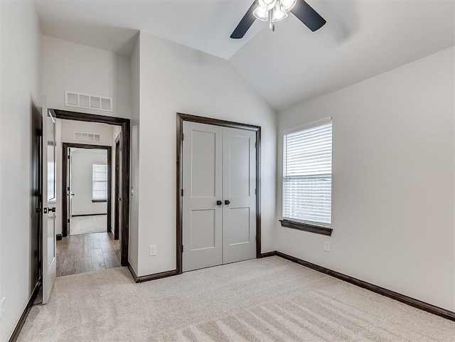 2436 NW 179th St, Edmond, OK 73012 - unfurnished bedroom featuring light carpet, lofted ceiling, a closet, and ceiling fan