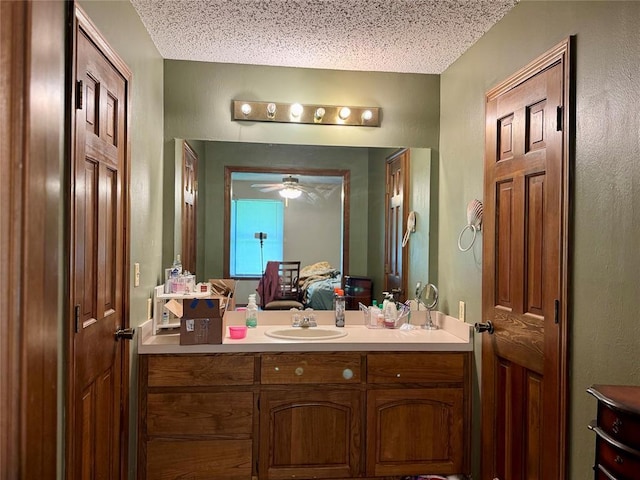 311 Parker St, Waurika, OK 73573 - bathroom featuring vanity, a textured ceiling, and a ceiling fan
