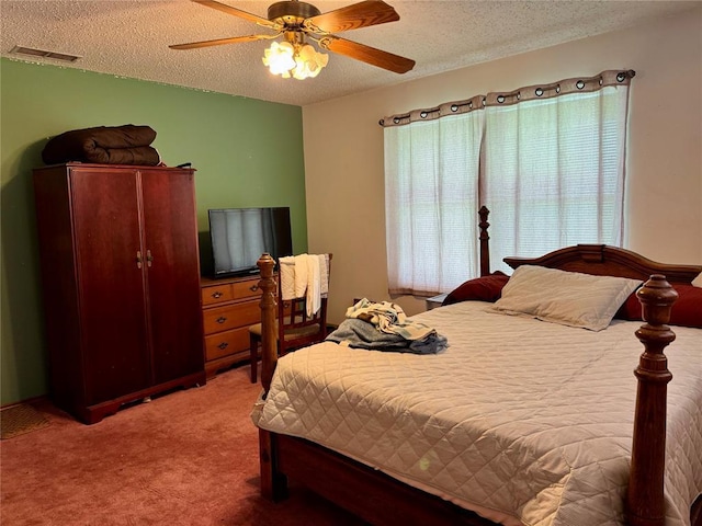 311 Parker St, Waurika, OK 73573 - carpeted bedroom featuring a textured ceiling and ceiling fan
