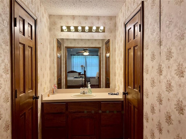311 Parker St, Waurika, OK 73573 - bathroom with vanity, ensuite bathroom, and wallpapered walls