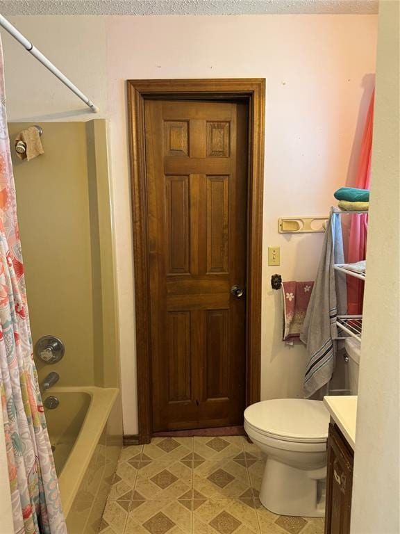 311 Parker St, Waurika, OK 73573 - full bath featuring vanity, shower / tub combo with curtain, and a textured ceiling