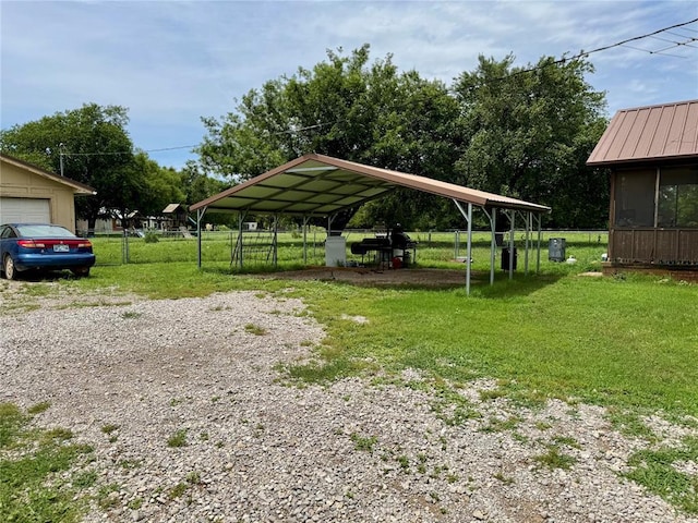 311 Parker St, Waurika, OK 73573 - view of vehicle parking featuring a carport and gravel driveway