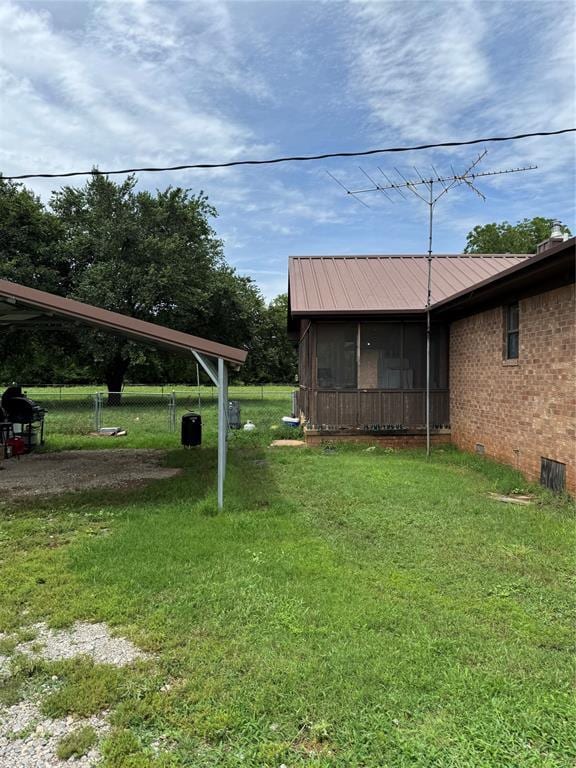 311 Parker St, Waurika, OK 73573 - view of green lawn featuring a sunroom