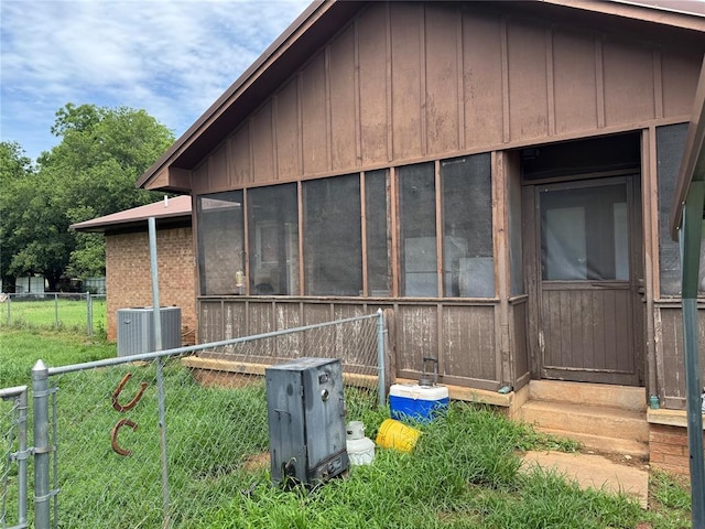 311 Parker St, Waurika, OK 73573 - view of property exterior featuring a sunroom and board and batten siding
