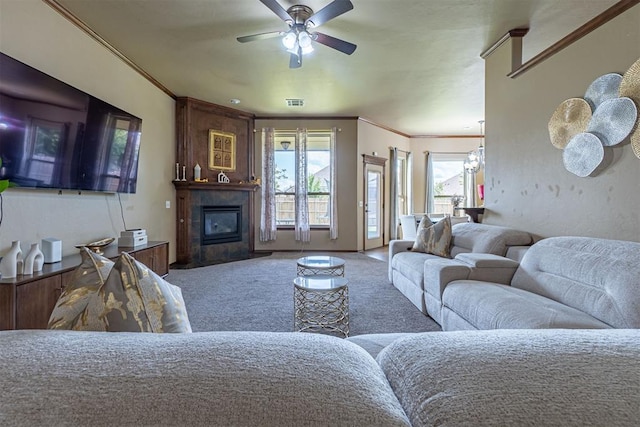 716 SW 157th St, Oklahoma City, OK 73170 - living area with carpet flooring, plenty of natural light, a ceiling fan, crown molding, and a large fireplace